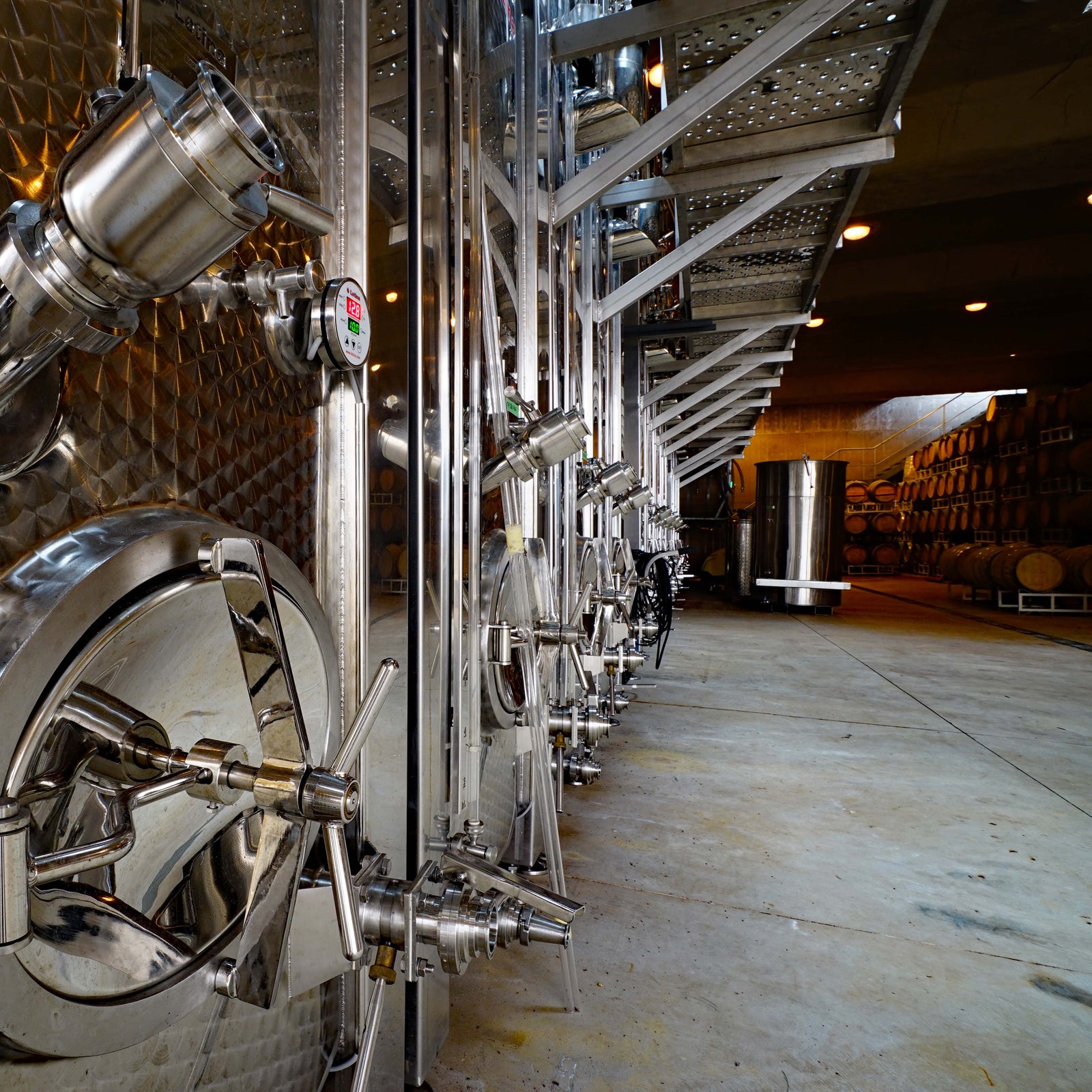 Stainless steel wine tanks inside the cave at Pentâge Winery